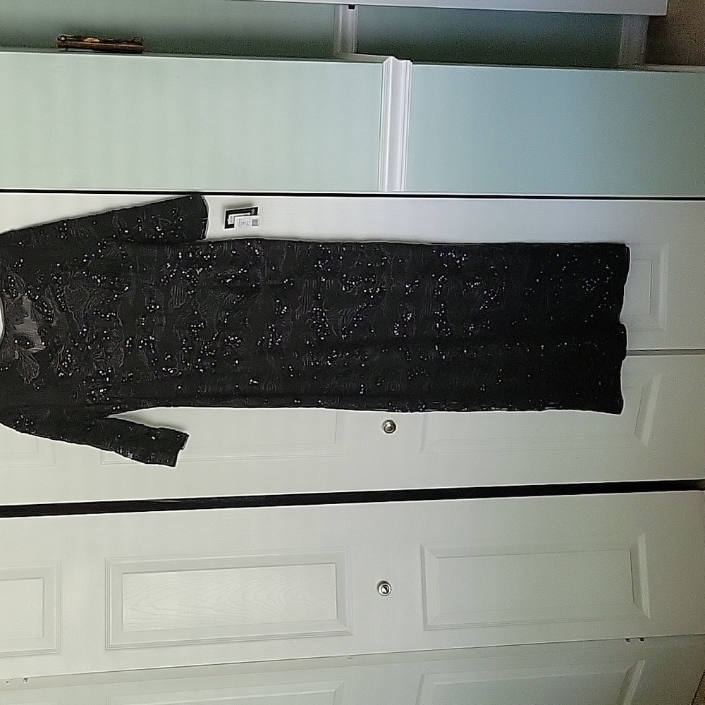 Brand new never used. Black long gown. Bought for a wedding but didn't wear it.